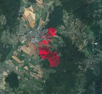 Aerial view of agricultural and forest lands around the city of Prievidza.