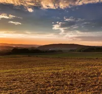 Sunset over the agricultural and forest lands in Boťany creates a picturesque landscape.