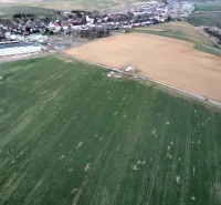 Aerial view of agricultural and forest lands around the village of Podhorany.