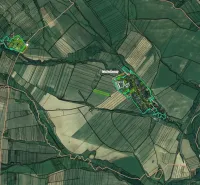 Aerial view of agricultural and forest lands around Podhorany, with visible parceling.