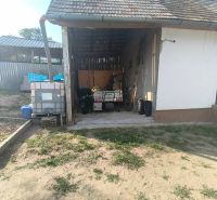 A family house in Dobroč on Dobroč Street, a shelter with tools and barrels for storage.