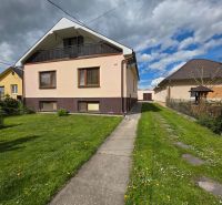 A family house on Sládkovičova Street in Veľké Úľany with a landscaped garden and a garage.