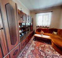 Living room in a family house with a sofa set and a carpet with ornaments.