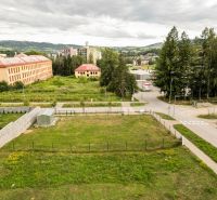A plot for residential use in Brezno in the Štvrť kasárne area, with a view of nature and buildings.