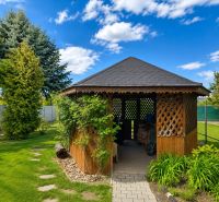 A garden with a gazebo at a family house on Hrnčiarska Street in Sereď, surrounded by greenery.