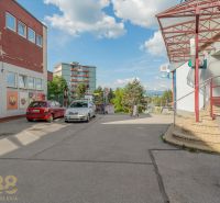 Parking lot in front of the building in Banská Bystrica with cars and outdoor staircases.