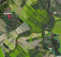 An aerial view of various agricultural fields and structures around Rapovce.