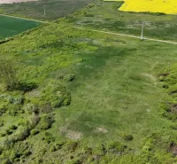 Aerial view of agricultural and forest land in Zemplínske Kopčany with diverse vegetation.
