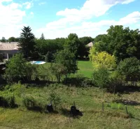 The landscape in Hronovce with residential plots, surrounded by greenery and a rural atmosphere.