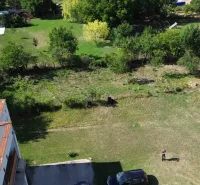 Aerial view of residential plots in Hronovce with greenery and parking.