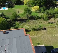 Plots - living in Hronovce: grassy area, trees, pool, roof, open nature.