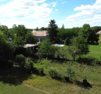 Greenery and houses in Hronovce, residential plots, with a visible swimming pool.