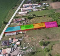 An aerial view of subdivided residential plots in Rakytník near the main road.
