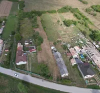 Aerial view of plots - housing in the town of Rakytník surrounded by houses and nature.