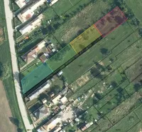 Aerial photograph of residential plots in Rakytník with divided parcels and buildings.