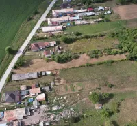 Aerial view of residential plots in Rakytník surrounded by nature and roads.