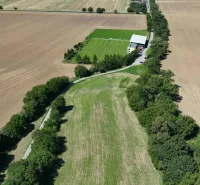 Agricultural and forest land in Nová Ves nad Váhom with a playground and a dirt road.