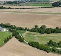 Agricultural and forest land in Nová Ves nad Váhom with a playground and surrounding nature.