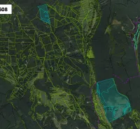 An aerial view of agricultural and forest lands around Brusno.