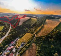 Aerial view of agricultural and forest land in Rokycany at sunset.