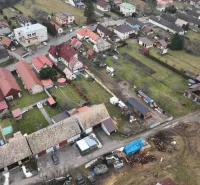 Aerial view of unusual properties in Kláštor pod Znievom with gardens and buildings.