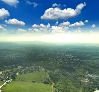 Aerial view of agricultural and forest land in Stupava under a clear sky.