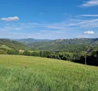 Extensive agricultural and forest lands in Petrova Lehota with views of the hills.
