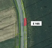 Aerial view of plots, agricultural and forest land in Hankovce near the road.