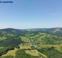Rolling landscape of agricultural and forest lands near Lysá pod Makytou under a blue sky.