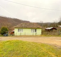 A family house in Kokava nad Rimavicou, with a wooden roof, situated by the road.