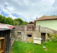 A family house in Kokava nad Rimavicou with a wooden fence and a grassy yard.