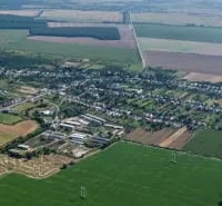 Aerial view of Trhovište with agricultural and forest lands surrounding the village.