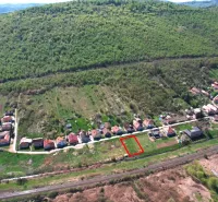 Lands - housing in Hodejov, bordered by green hills and a railway track.