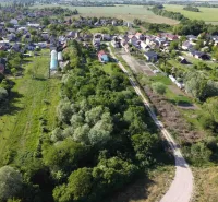Aerial view of the Gardens in Branč, surrounded by greenery and houses.