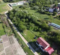 Aerial view of gardens in Branč with a house and a greenhouse.