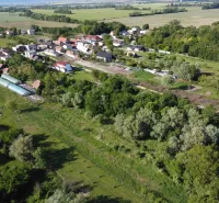 Aerial view of the garden area around the town of Branč, surrounded by greenery.