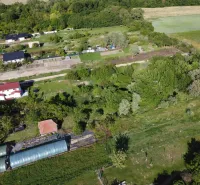 Aerial view of the Gardens in Branč with multiple buildings and greenery.