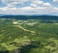 Panorama of agricultural and forest lands in Ábelová with lush green landscape.