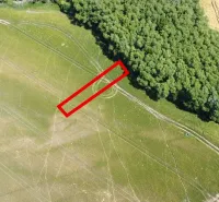 An aerial view of agricultural and forest land in Kozárovce with a highlighted rectangle.