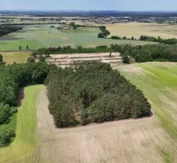 Aerial view of agricultural and forest lands around Lozorno with extensive forests.