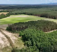 Aerial view of agricultural and forest lands near Lozorno with cultivated fields and forests.