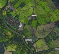 Aerial view of agricultural and forest lands around the town of Zemné.