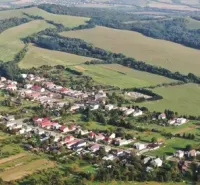 An aerial view of Rovné surrounded by agricultural and forest lands.