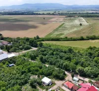 Originating from Parchovany, this photograph captures rural lands surrounded by greenery.