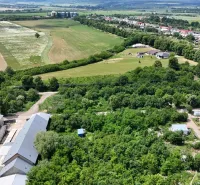 Aerial view of properties - housing in Parchovany with green fields and buildings.