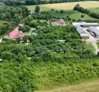Aerial view of plots - housing in Parchovany, surrounded by greenery and buildings.