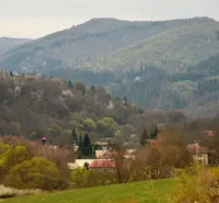 Panorama of forest lands near Horný Tisovník with gentle hills and trees.