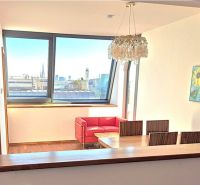 Dining area in a 2-room apartment with a view and wooden decor flooring.