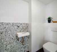 A bathroom with stylish mosaic tiles in a 4-room apartment.