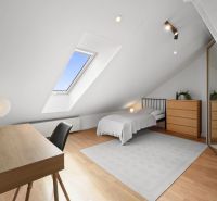 Attic room with a skylight, bed, and desk, 4-room apartment.